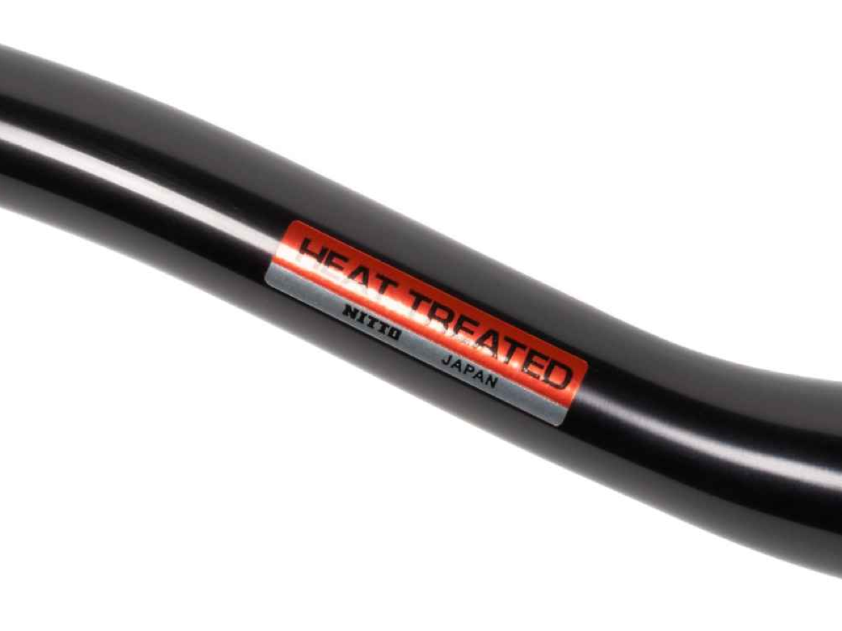 Close-up of the Nitto Heat Treated label on the Sync XL black handlebar, made in Japan