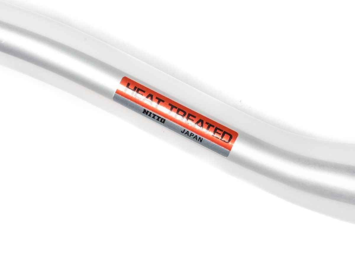 Close-up of the Nitto Heat Treated label on the Sync XL silver handlebar, made in Japan